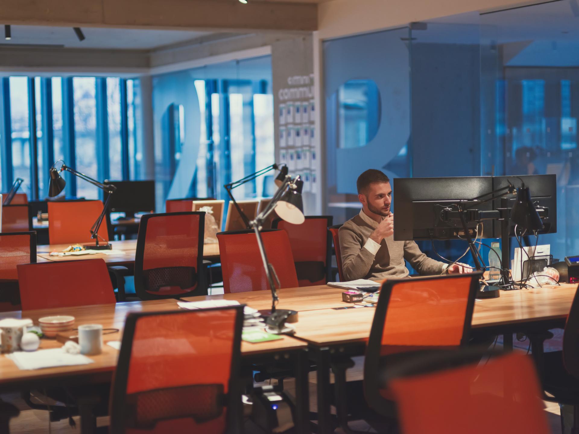 Split screen showing productive team meeting vs empty offshore office at night